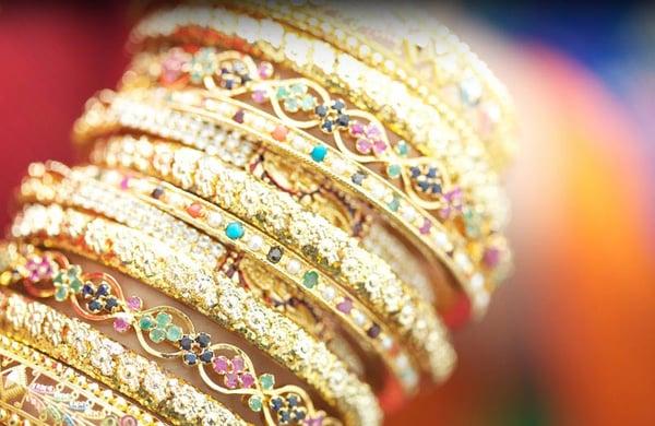 Close-up shot of wedding bangles reveal intricate details in each ring.