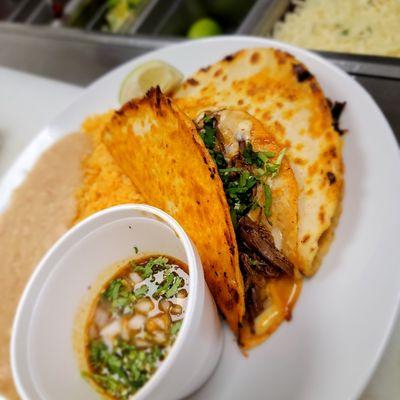 Quesabirria quesadillas with flank steak and cilantro onion also comes with dipping sauce