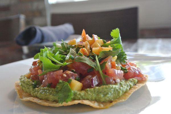 Tostada Atun with marinated ahi tuna, sikil p'ak verde, & herb salad