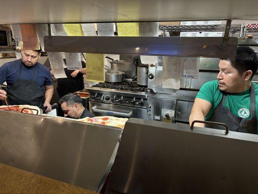 Cooks working assembly line.