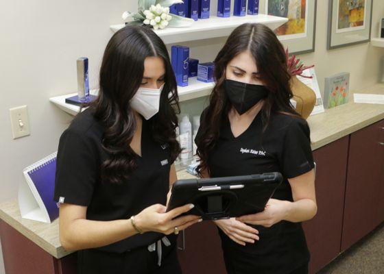 PA Stephanie Kaiser and medical assistant reviewing a chart at the Dermatology & Laser Center of San Antonio