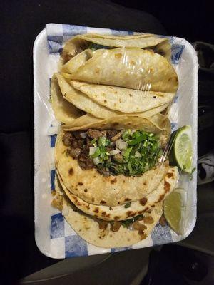 Beef and chicken tacos with cilantro and onions