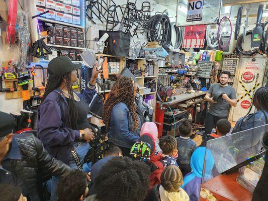 Bolt Bike shop manager giving our students and their families a tour of the store, wheel parts and definition plus a wheel repair demonstrat