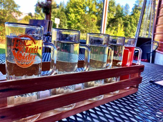 Flight of hard ciders out on their patio.