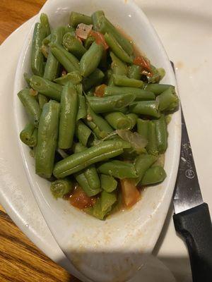 Green beens have onions and tomatoes. Tasty