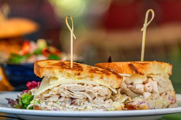 Chef's Roasted Turkey Sandwich made with House Smoked Herb Turkey Breast, Mustard Slaw, Aioli, Manchego Cheese on Toasted Soughdough