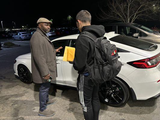 Zack showing my son how to use his car