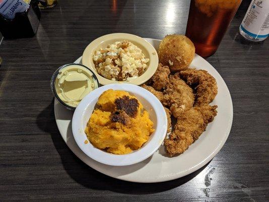 Fried chicken tenders with corn casserole, sweet potato casserole, and cornbread