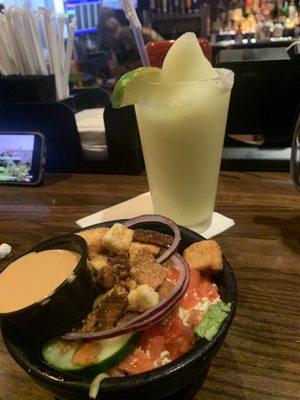 Side salad with frozen margarita in the background