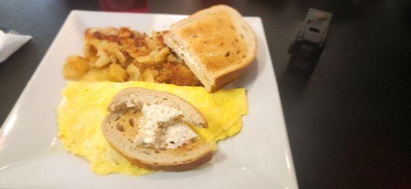 Egg omelet, patatoes, and rye bread.