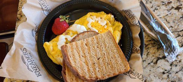 Mexican Omelet - 3 ounce scrambled omelet with Pico De Gallo, cheddar cheese and crema. Served with toast and a fresh strawberry.