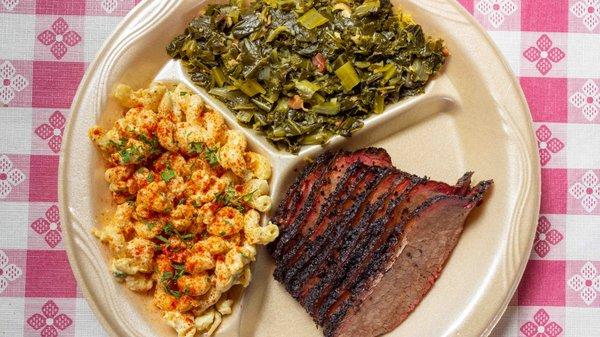 Brisket plate with pasta salad and collard greens.