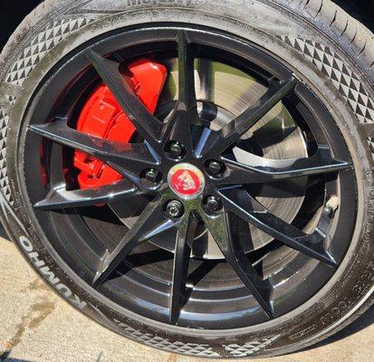 OEM wheels after powder coating black and OEM calipers painted red