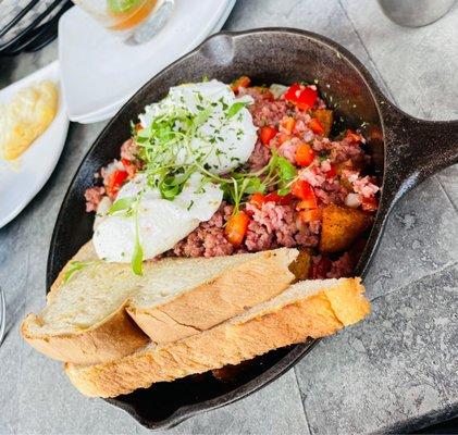 Corn, beef, hash, and egg skillet.