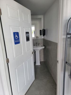 Wheelchair accessiblability unisex bathroom.