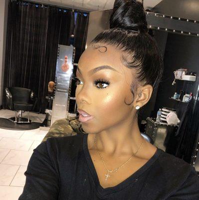 Full lace wig styled and pulled up into a sleek bun.