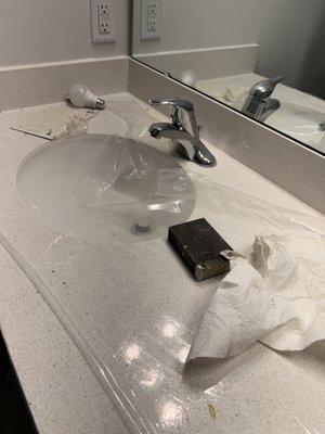 trash on the granite counter tops. The sink was scratched from someone breaking the protective plastic