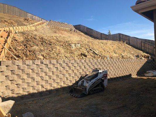 Built retaining wall after removing granite rock