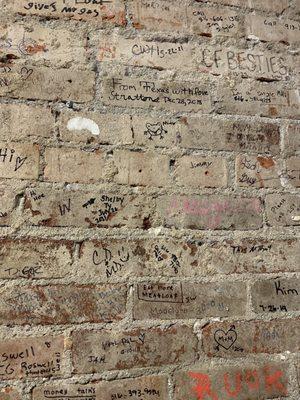 Love the signed brick wall