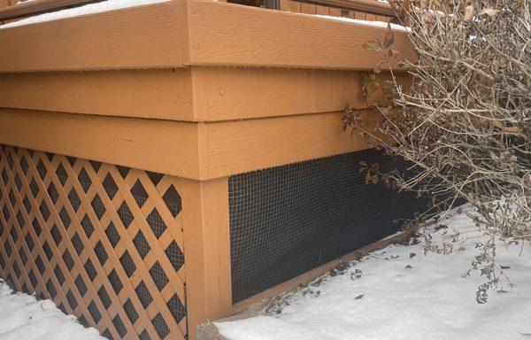 Chicken wiring with black material added underneath the full length of the deck.