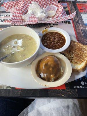 Chicken and dumplings with baked beans and potatoes and gravy