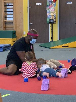 Mr. Karl leading some play time while the parents watch from the lobby area. Helping the kids to feel confident away from the parents.