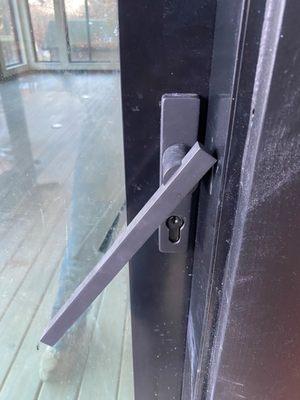 top of door handle colliding with door frame, also note the poor fit of the lock and color disparity between door and handle