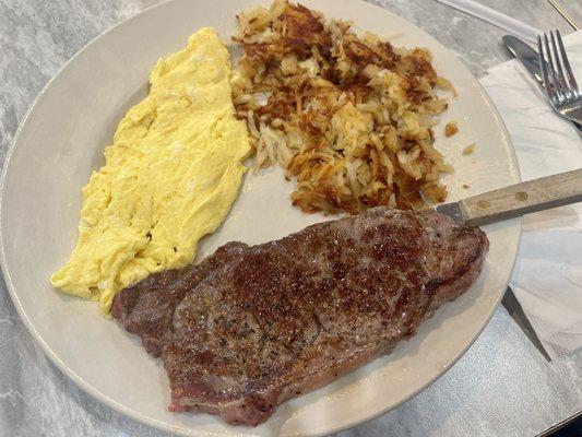 Sirloin steak cooked perfectly to medium rare with hashbrowns and scrambled eggs- all cooked in butter, for the win!