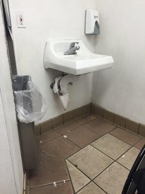 Dirty sink. Empty soap dispenser. Look how nasty that floor is!