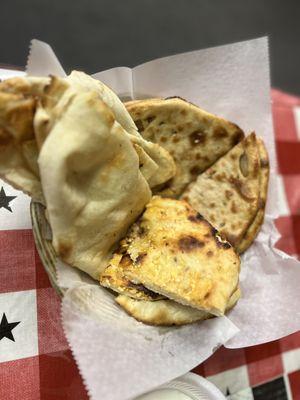 Basket of plain naan, cheese naan and paratha