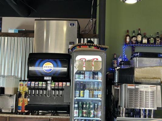 Self serve Pepsi fountain. You get your cups at the bar