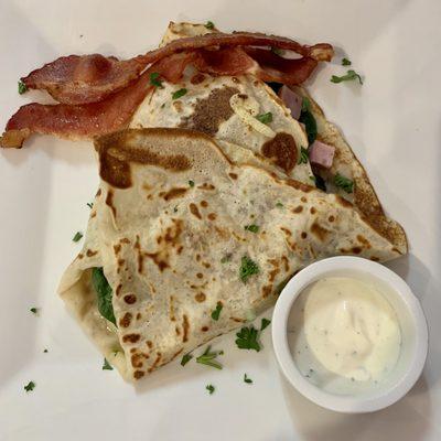 Crepe #10: Swiss cheese, Petit Jean ham, fresh spinach and tomato, with bacon and Mediterranean sauce.