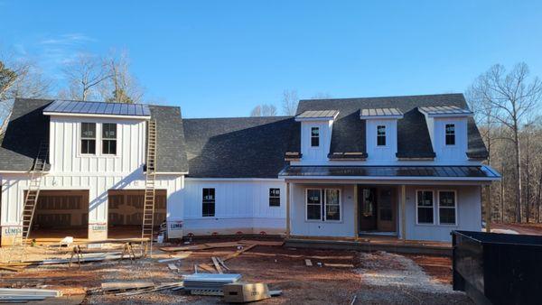 We covered the 3 Eyebrows, the Big Eyebrow to the left.  Also the Front porch in Black Striated 16" Standing Seam