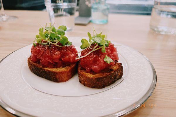 Tuna tartare, on a local sourdough crostini toasted in a cultured miso butter, micro greens