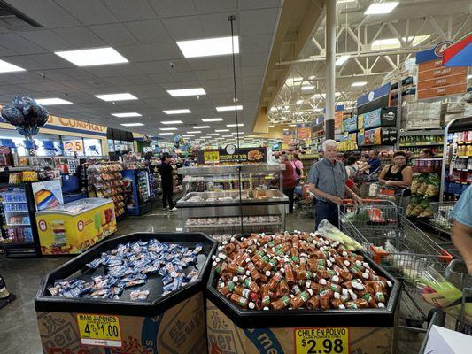 People waiting in line. Only 3 cashiers open. Very long lines; probably 15 to 20 people waiting In line for each cashier.