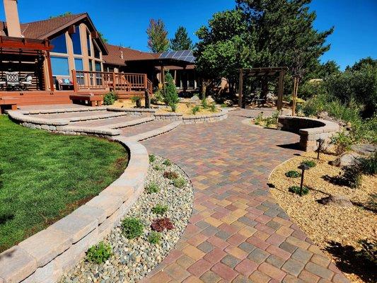 Landscaping with pavers, plants, and fountains