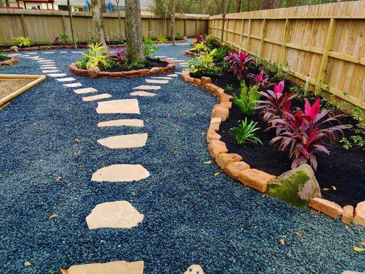 New Moss rock, black star gravel and flagstone stepping stones.