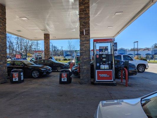 Outside at the gas station, facing south towards Elmsley Meadows Ln. S Elm-Eugene St to my left. View from pump 8 of 24.