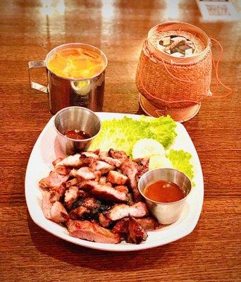 Kor Mu Yaang .. char Grilled pork with smoked chili and tamarind sauce Thai Iced Tea and Sticky Rice