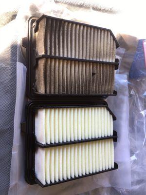 A dirty engine air filter that was never changed, next to the new one I purchased.