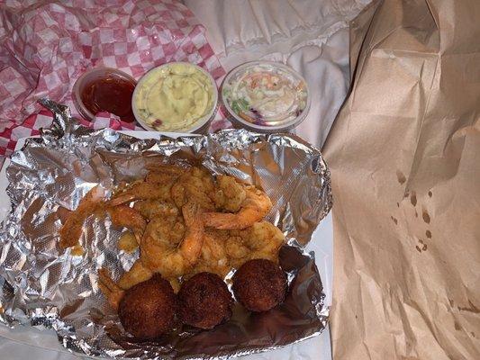 Fried shrimp hush puppies coleslaw and potato salad