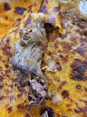 silverskin, not meat even though in a pic it looks like it could be meat.. this was throughout the entire quesadilla