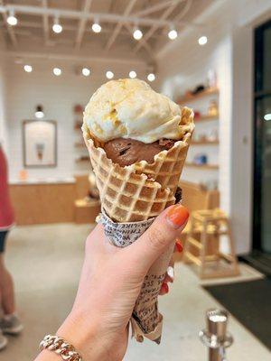 Two scoops in a Buttercrisp Waffle Cone: Darkest Chocolate and Butterscotch Popcorn