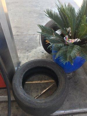 Discarded tires left at the islands broken glass in the pump station pathway trashcan's overflowing