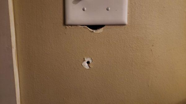 Unnecessary drilled holes and torn out portion of our light switch. Very sloppy work.