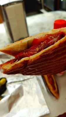 Basturma sandwich - Thinly shaved air-dried cured seasoned beef slices with pickles and tomatoes in a panini pressed like crispy bread.