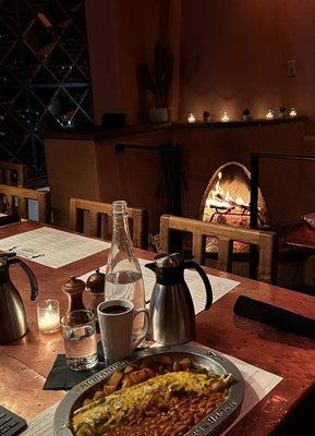 back room family table at Dick's Hideaway with kiva fireplace, rustic wine racks and my favorite breakfast burrito!