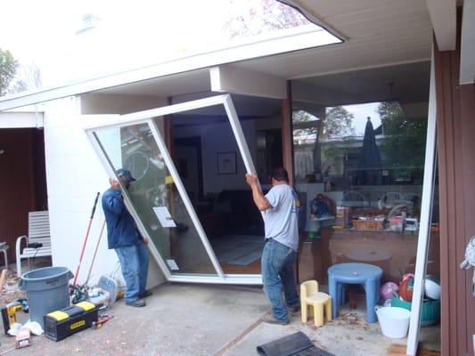 Miguel and Oscar install a new patio door on a Eichler home in Novato.