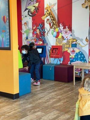 Colorful waiting area with tablets