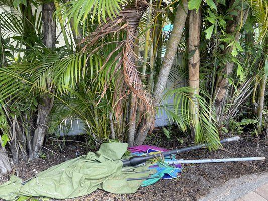 2 broken outdoor umbrellas left on the side of the lanai